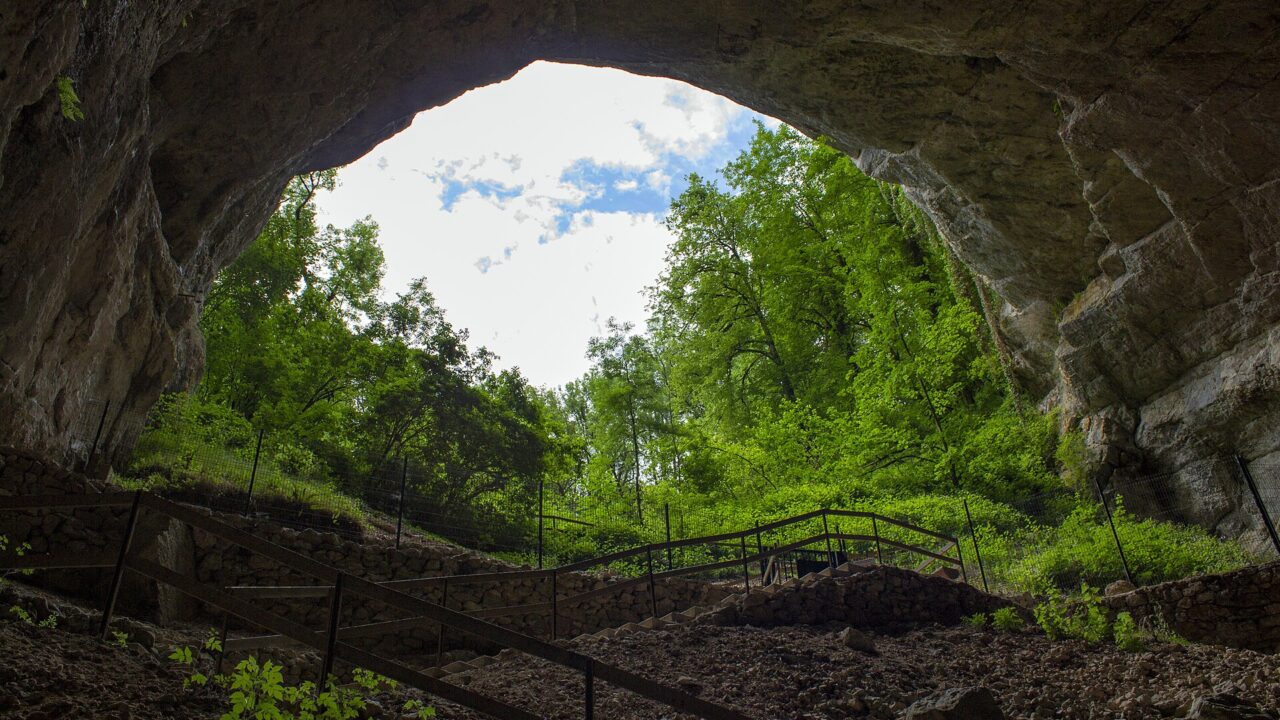 L'arche d'entrée des Grottes du Cerdon ouvrant sur la forêt